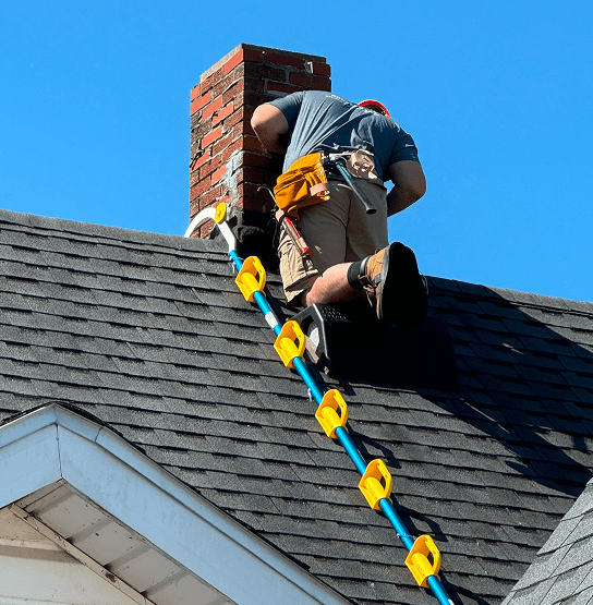 Roofer working around chimney 