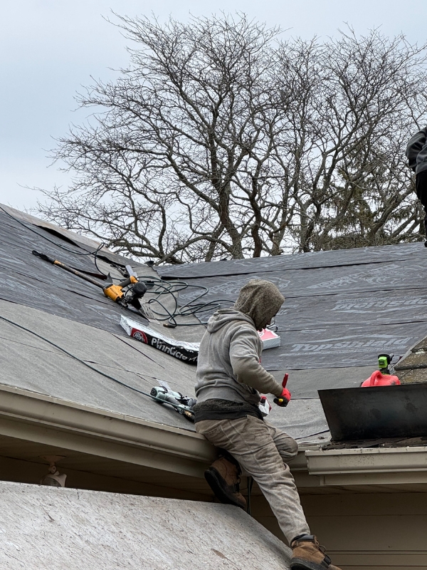 Roofer working on residential roof
