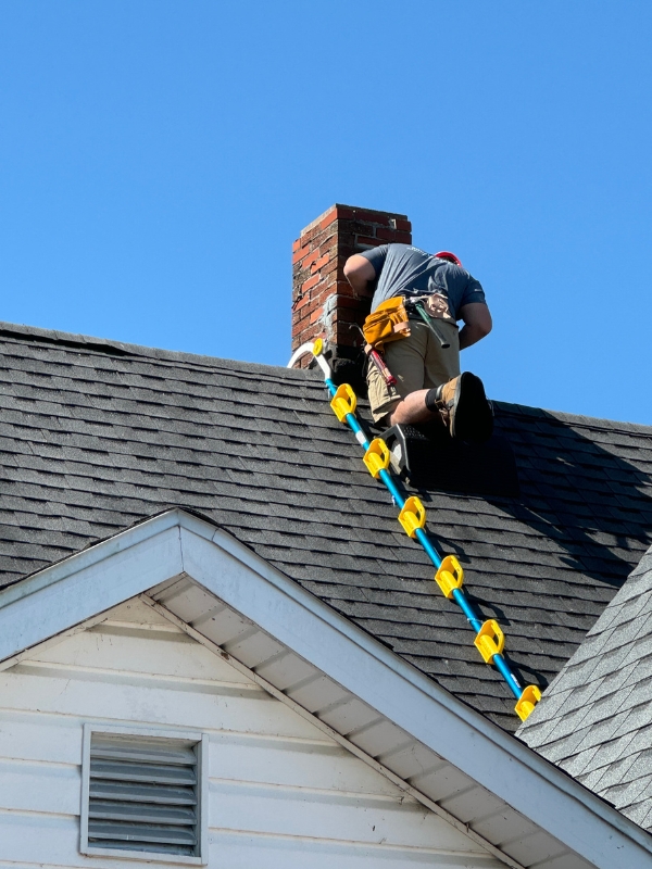 Roofer ascending chimney safely