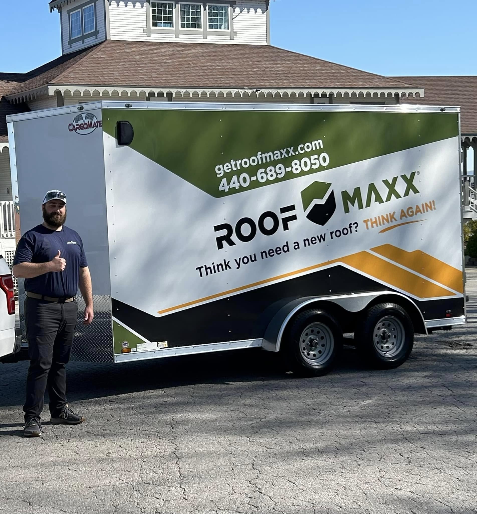 Brett York standing in front of a Roof Maxx trailer