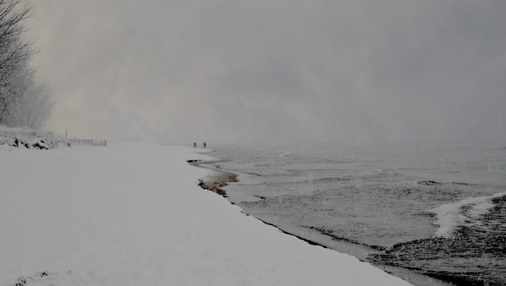 A winter storm against a lakeshore.